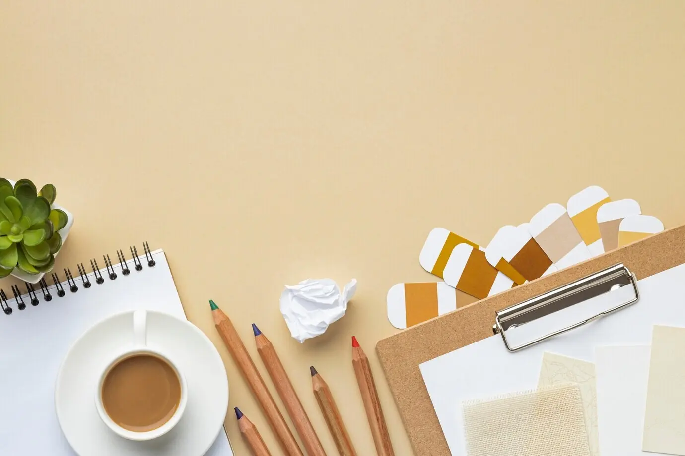 Overhead view of a house renovation notebook with colored pencils and copy space.