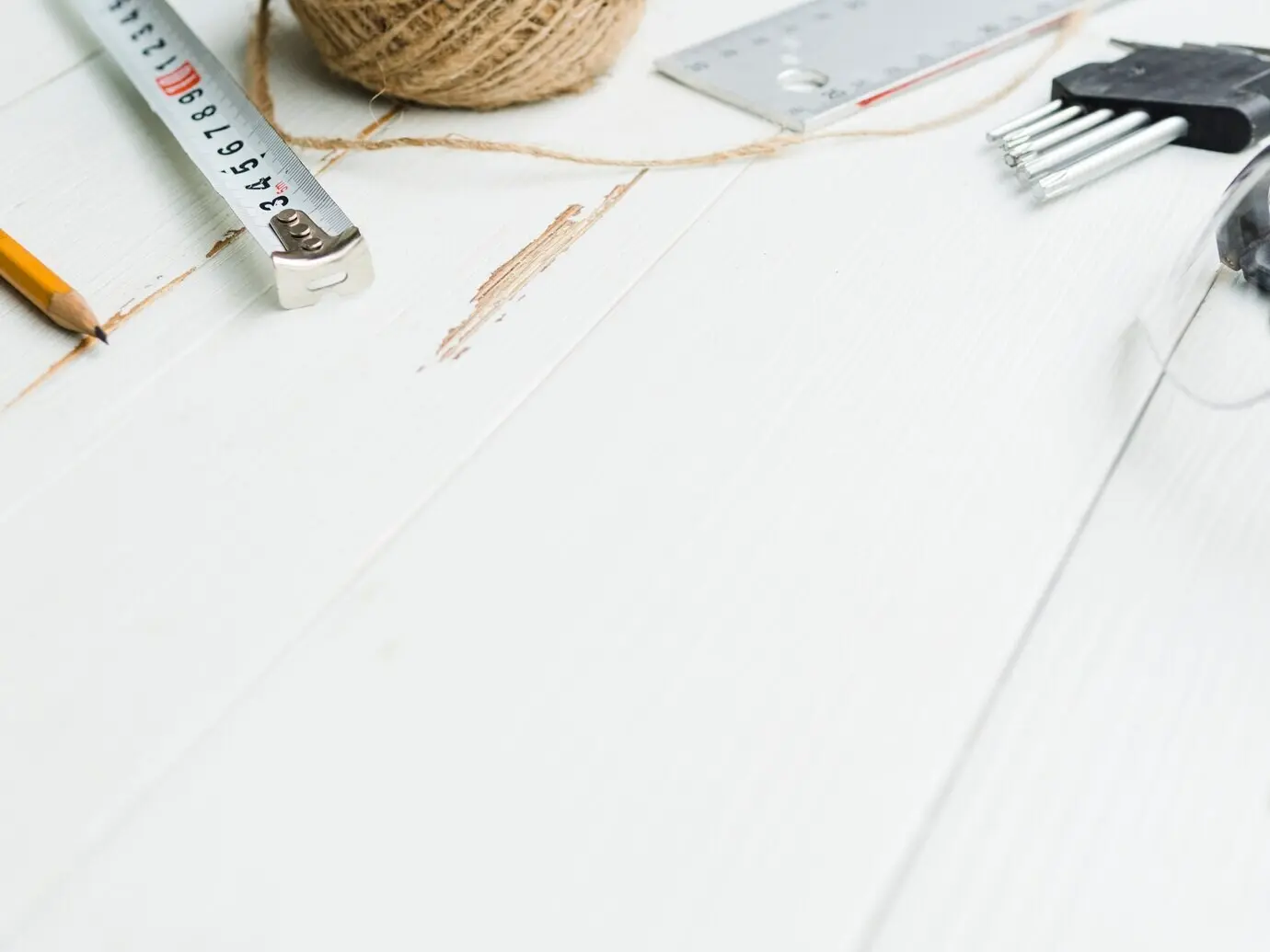 Measuring tools next to a skein of twine and nozzles for a perforator.